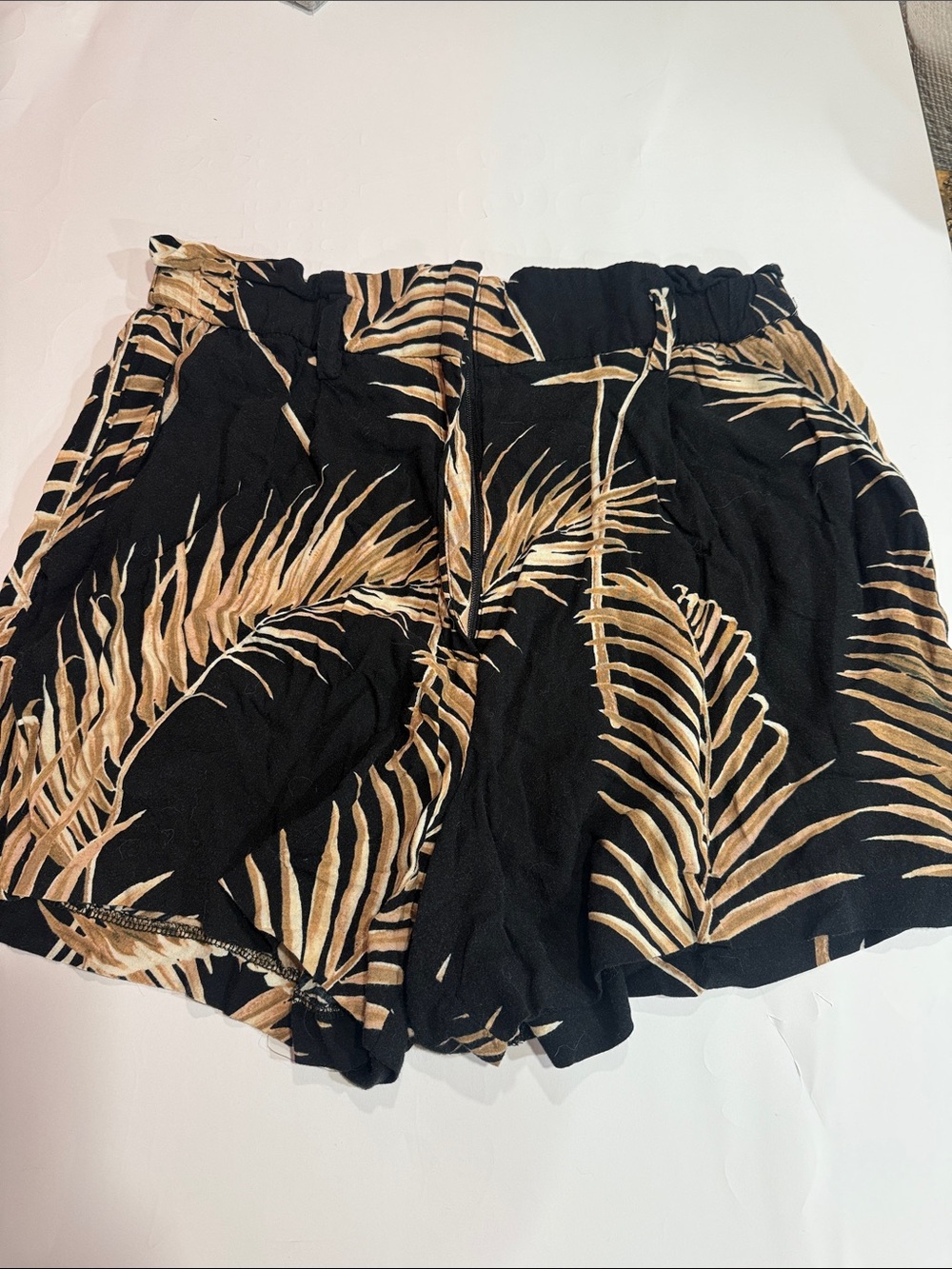 H+M stretchy black with tan palm shorts. Size 6